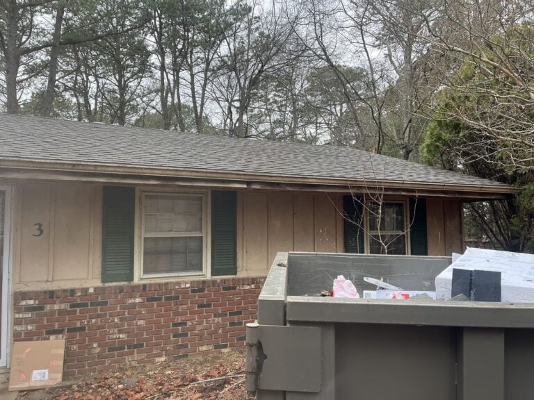 Professional roofing contractor inspecting gutters and roof condition during spring maintenance visit at New Jersey home